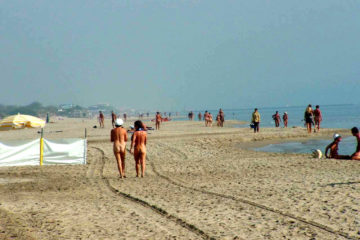 Nude couple walks along Cap D' Agde