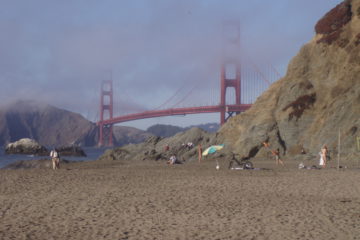 Nudist couple enjoying the view of the Golden Gate Bridge at Baker Beach